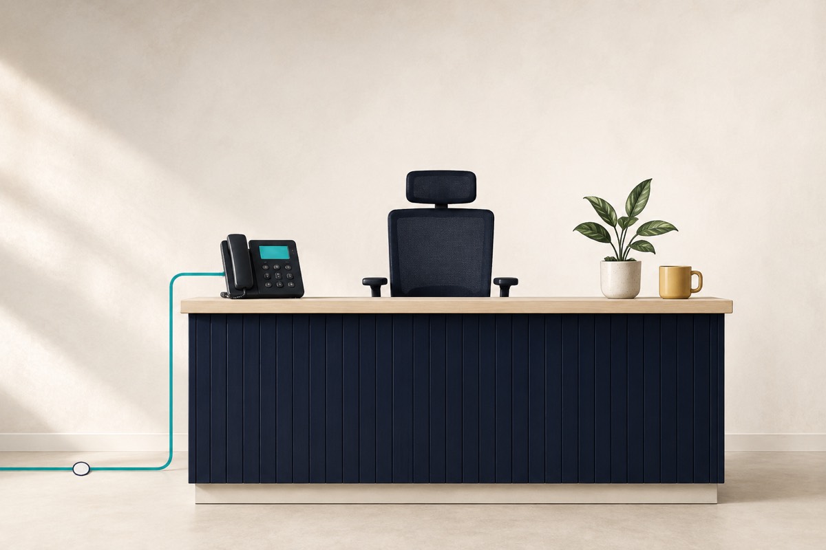 Illustration of an empty reception desk with a desk phone connected to a line